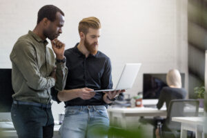 Two men reviewing the RAC audit process on a laptop