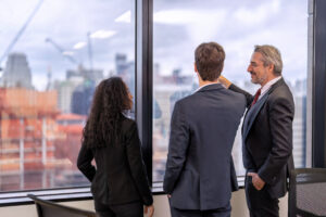 Three business professionals discussing future perspectives on billing audits in healthcare.